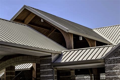 vlack metal roof with white house|sloped roof fbi.